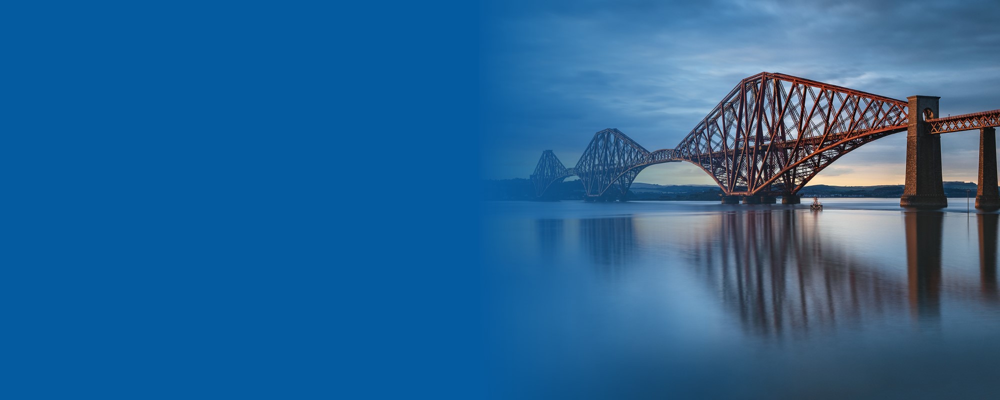 A image of the dark red Forth Rail bridge, with the river below and a blue sky above. The left side of the image is a block of blue colour.